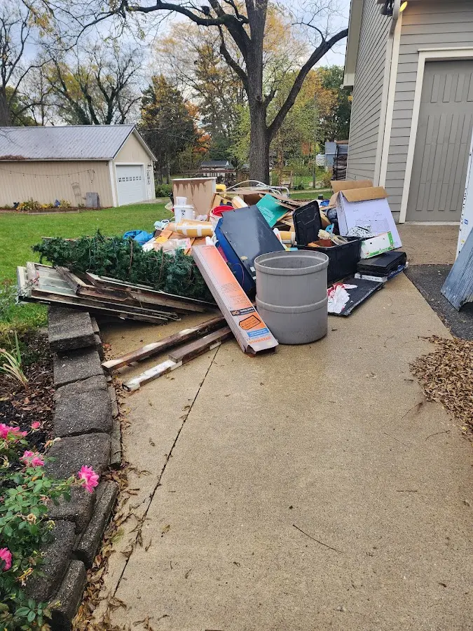 Dumpster being loaded with debris for Commercial Dumpster Rental in Great Barrington